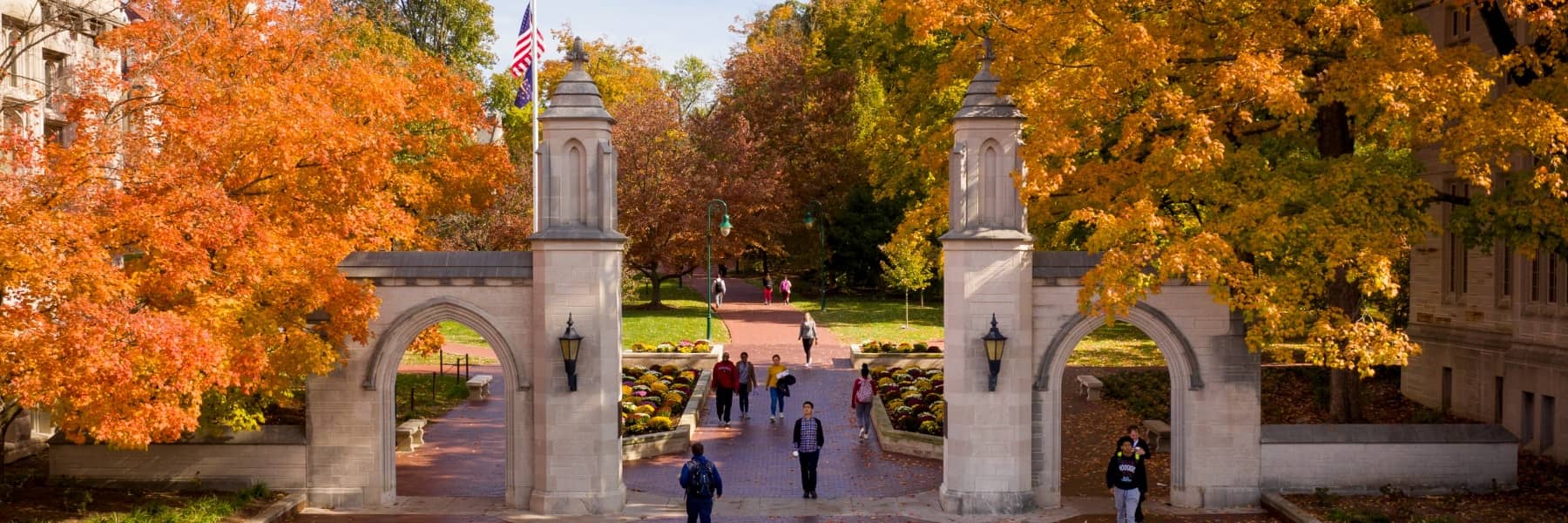 Photo of the Sample Gates in the fall with students walking.